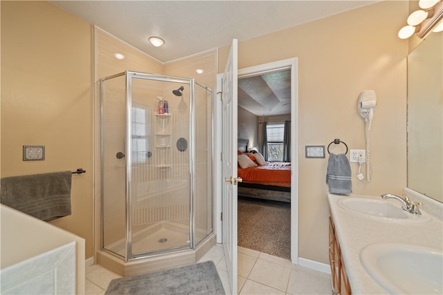 bathroom featuring tile patterned flooring, a textured ceiling, vanity, and walk in shower