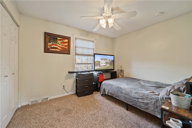 carpeted bedroom featuring ceiling fan and a closet