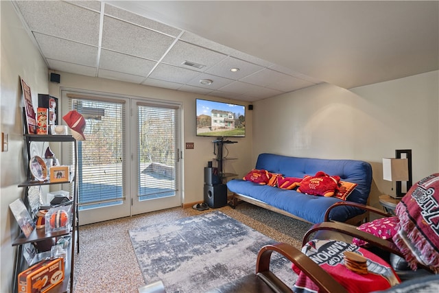 living room with a paneled ceiling