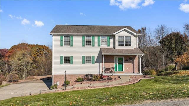 view of front property with a front lawn and covered porch