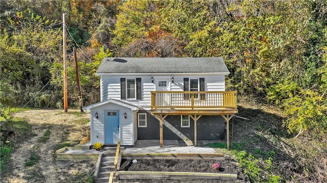 view of front of home featuring a wooden deck and a patio area