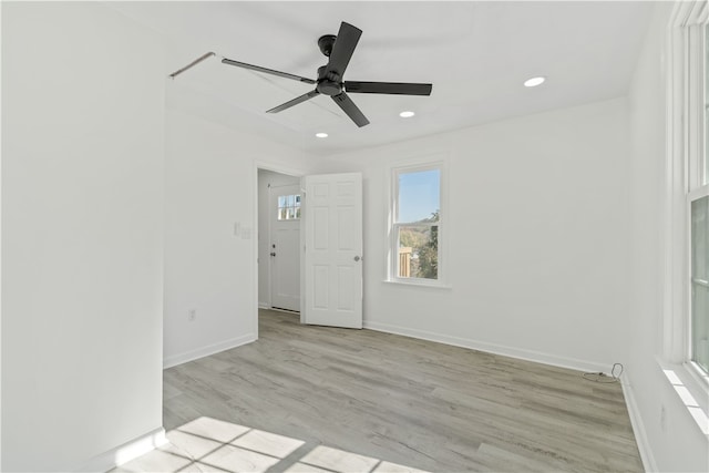 unfurnished room with ceiling fan and light wood-type flooring