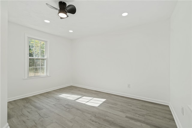 empty room with light hardwood / wood-style floors and ceiling fan