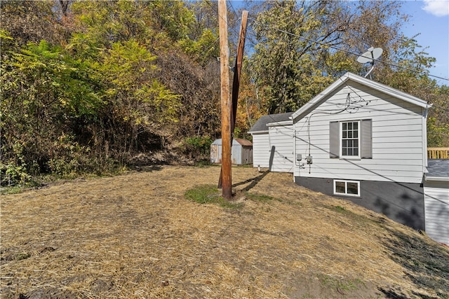 view of side of property featuring a shed