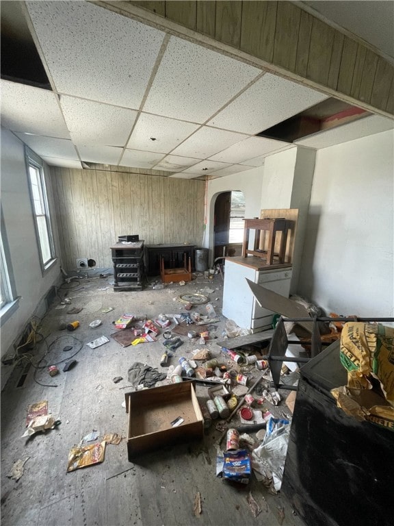 misc room with wooden walls and a paneled ceiling