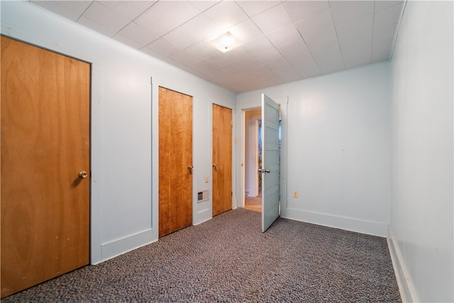 unfurnished bedroom featuring dark colored carpet