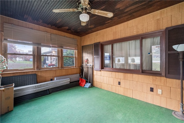 interior space with ceiling fan