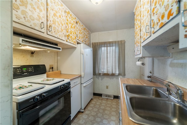 kitchen featuring white cabinetry, sink, and white appliances