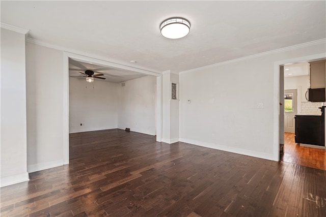 empty room featuring ornamental molding, ceiling fan, and dark hardwood / wood-style flooring