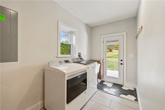 clothes washing area with electric panel, independent washer and dryer, and light tile patterned floors