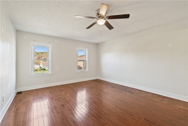 unfurnished room with dark hardwood / wood-style floors, a textured ceiling, and ceiling fan