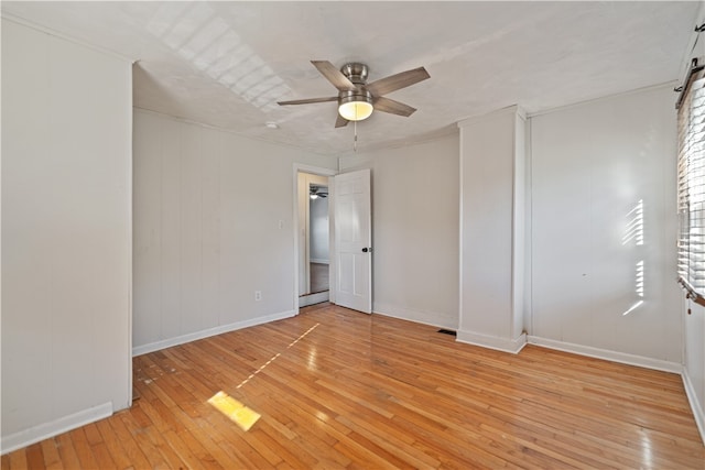 spare room featuring light hardwood / wood-style floors and ceiling fan