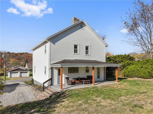 back of property featuring a patio, an outbuilding, a lawn, and an outdoor hangout area