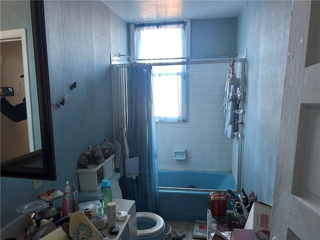 bathroom featuring toilet and shower / bath combo with shower curtain