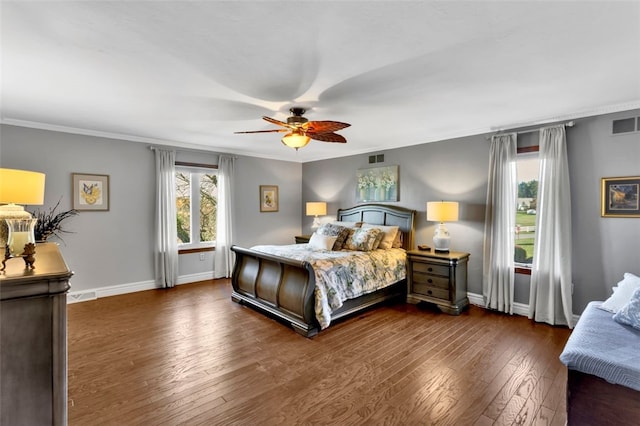 bedroom with dark hardwood / wood-style flooring, crown molding, and ceiling fan