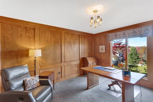 office with dark carpet, an inviting chandelier, and wood walls