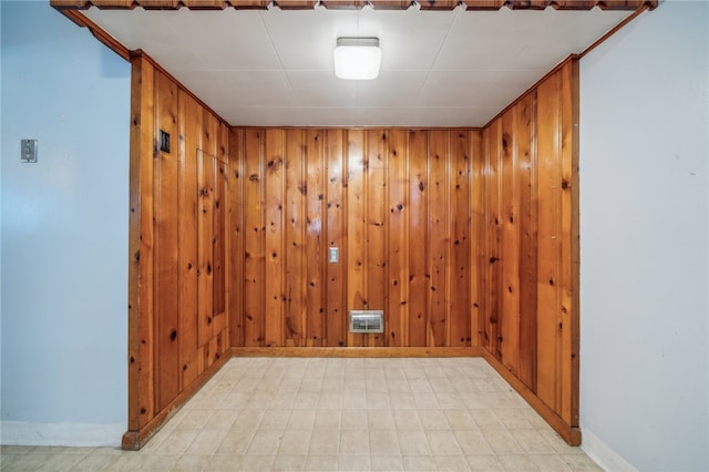 spare room featuring wooden walls