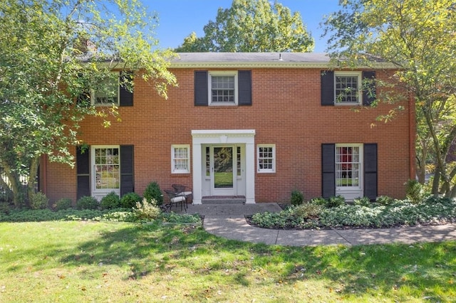 colonial-style house with a front yard