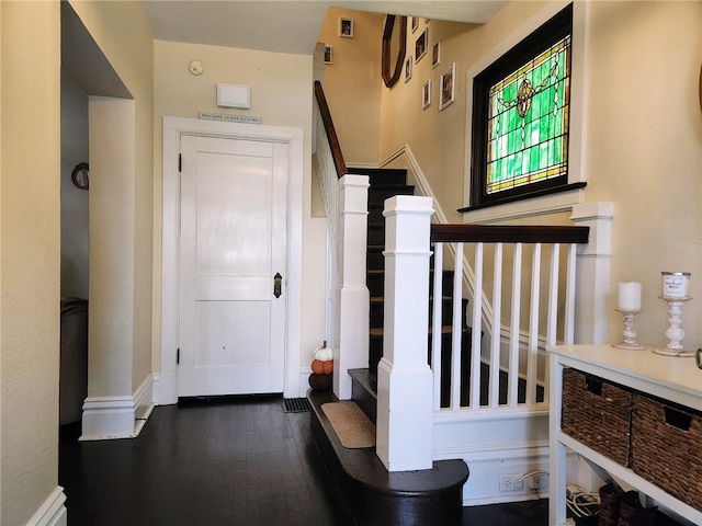 entryway with dark hardwood / wood-style flooring