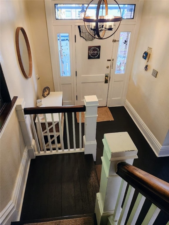 foyer featuring a chandelier and dark hardwood / wood-style floors