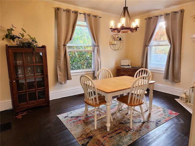 dining area featuring a notable chandelier, ornamental molding, and dark hardwood / wood-style flooring