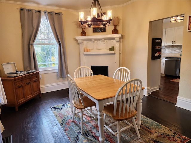 dining area with crown molding, a chandelier, and dark hardwood / wood-style flooring