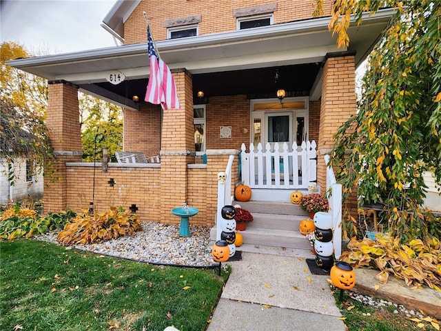 view of exterior entry with covered porch