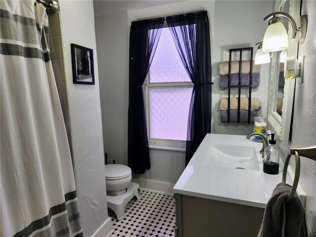 bathroom featuring vanity, curtained shower, and toilet