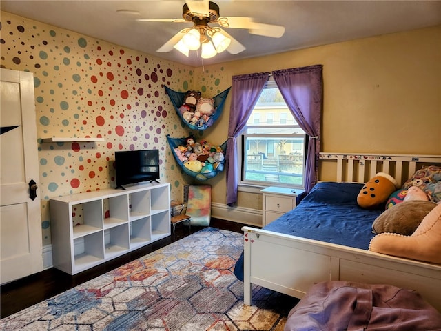 bedroom featuring ceiling fan and dark hardwood / wood-style floors