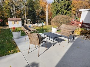 view of patio with a storage shed