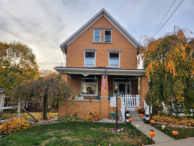 view of front of house with a front yard and a porch