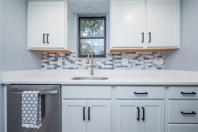 kitchen featuring sink, backsplash, white cabinetry, and dishwasher