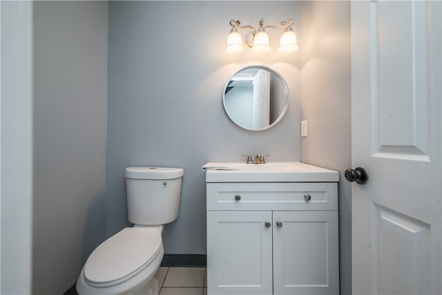 bathroom with vanity, toilet, and tile patterned flooring