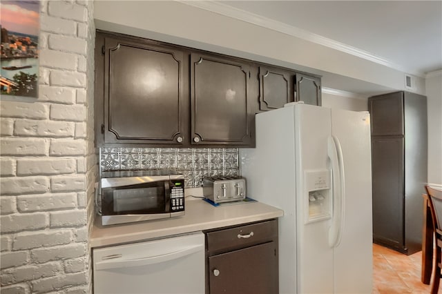 kitchen featuring crown molding, light tile patterned flooring, dark brown cabinets, and white appliances