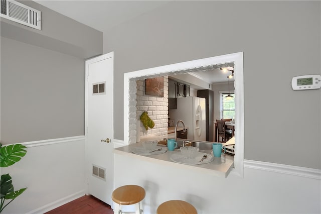 kitchen featuring white refrigerator with ice dispenser and dark hardwood / wood-style floors