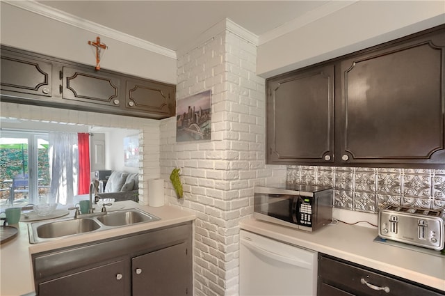 kitchen featuring white dishwasher, crown molding, dark brown cabinetry, and sink