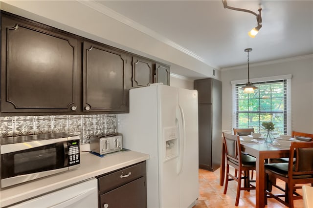 kitchen featuring white refrigerator with ice dispenser, decorative light fixtures, crown molding, decorative backsplash, and light tile patterned floors