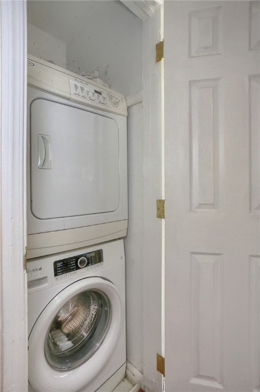 laundry area with stacked washer and dryer