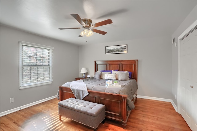 bedroom featuring a closet, light wood-type flooring, and ceiling fan