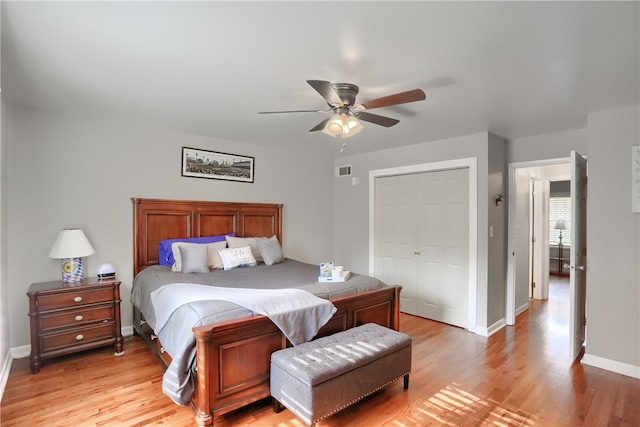 bedroom featuring light wood-type flooring, a closet, and ceiling fan