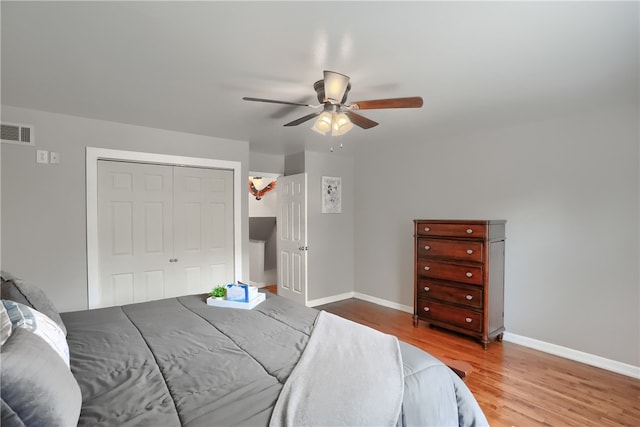 bedroom with a closet, ceiling fan, and wood-type flooring