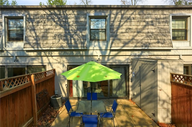 view of side of home with cooling unit and a patio area