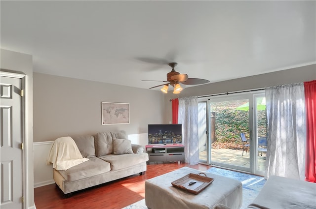 living room with ceiling fan and dark hardwood / wood-style flooring