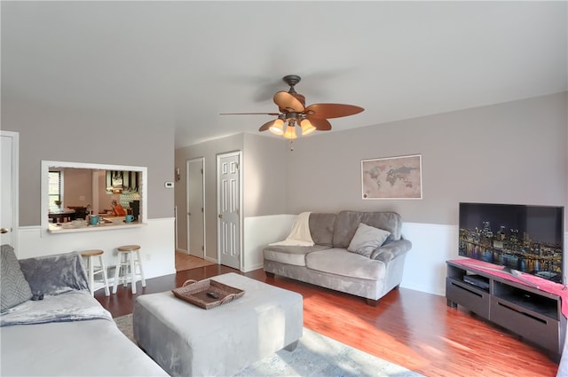 living room with ceiling fan and hardwood / wood-style floors