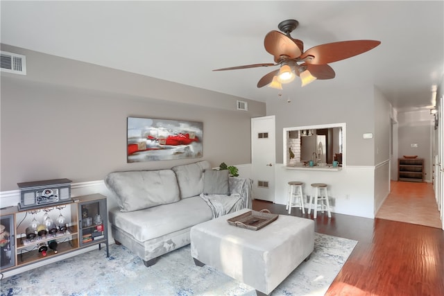 living room with wood-type flooring and ceiling fan