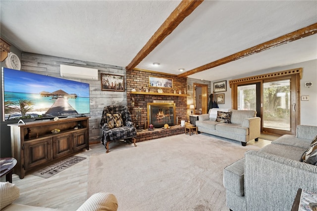 carpeted living room featuring a wall unit AC, a textured ceiling, a brick fireplace, beamed ceiling, and wooden walls