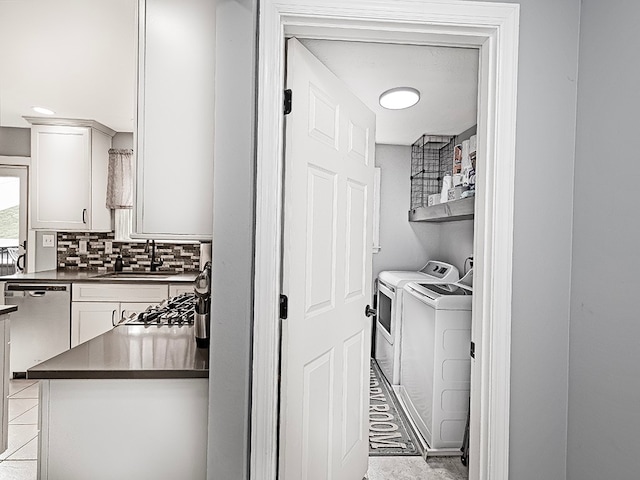 clothes washing area featuring washing machine and clothes dryer and sink