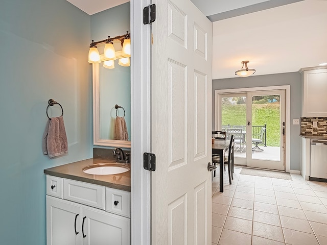 bathroom featuring vanity, tasteful backsplash, and tile patterned floors