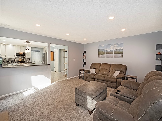 living room featuring light carpet and a textured ceiling