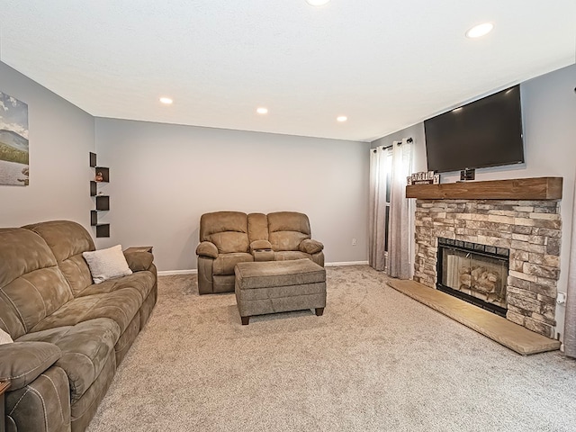 living room with light carpet and a stone fireplace